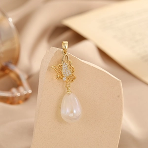 Detailed view of a gold butterfly pendant featuring a water-drop pearl and zirconia accents