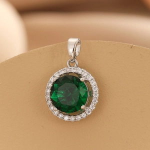 Elegant four-claw silver pendant featuring a large green round gemstone with white zircon halo