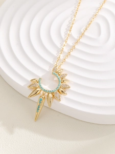 Detail of sunburst pendant with turquoise beads and micro-pave crystals on gold necklace