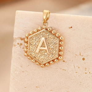 Golden hexagonal initial A pendant with hammered texture and beaded border detail