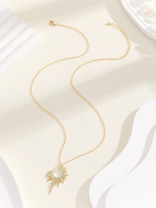 Detail of gold sun flower necklace with blue turquoise stone and spiked crescent pendant