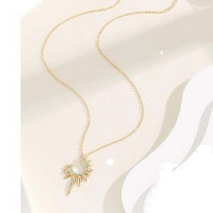 Golden tarot sunburst necklace with turquoise stone and sparkling zircon accents