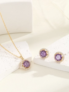Macro view of purple round cubic zirconia necklace and stud earring jewelry set