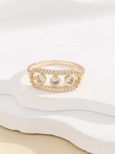 Detail of gold rectangle ring with micro-paved diamonds and three inset round stones