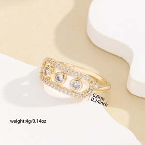 Elegant gold ring with rectangular frame and three clear stones in a modern design