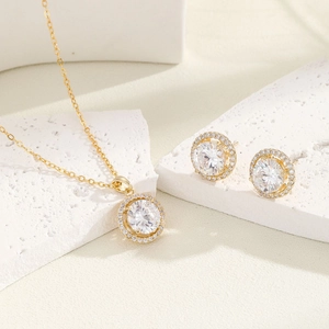 Elegant gold necklace and stud earrings set featuring large round halo cubic zirconia stones