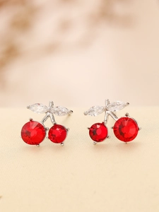 Detailed view of red crystal cherry earrings with silver stem and clear marquise leaves