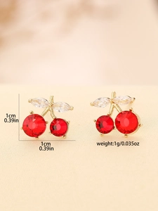 Macro detail of red crystal cherry earrings with gold base and clear leaf accents