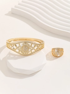 Detailed view of luxury gold hollow-out floral jewelry set with pavé cubic zirconia