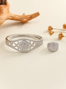 Macro detail of silver-plated jewelry set with hollow filigree and micro-pave zircons