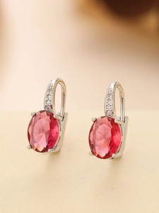 Detailed macro of oval-cut pink gemstone earrings with pave-set sparkling zircon accents