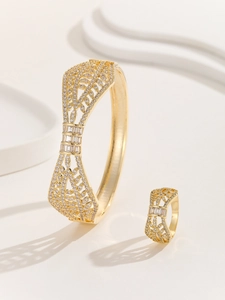Detailed close-up of gold镂空hollow-out floral bracelet and ring set with cubic zirconia