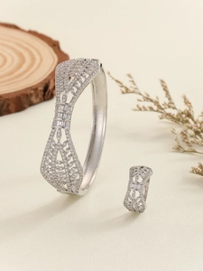 Macro shot of silver hollow-out flower jewelry set with pave-set cubic zirconia stones