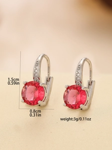 Close-up of vintage style earrings with round red rubies and dimensions of 1.5cm by 0.8cm