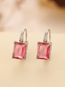 Macro detail of rectangle pink gemstone earrings with silver hook and zircon accents