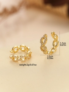 Detailed close-up of golden chain ear cuff featuring pink cubic zirconia and size dimensions