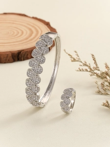 Macro shot of silver hollow-out wave pattern jewelry set with pavé cubic zirconia