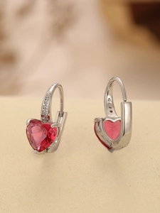 Detail of silver heart-shaped red zircon earrings with shimmering pave micro-inlays