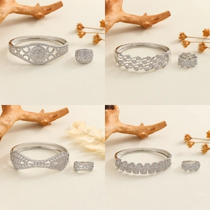 Silver jewelry set featuring micro-pave hollow patterns with bangles and matching rings