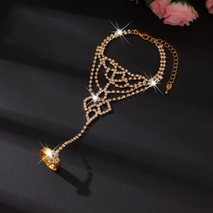 Macro shot of gold hand chain with rhinestones and adjustable lobster clasp closure