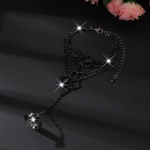 Macro shot of gothic black rhinestone slave bracelet with adjustable ring and chain link