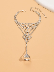 Detail of silver rhinestone finger bracelet with mesh pattern and adjustable lobster clasp