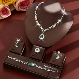 Elegant silver bridal jewelry set with pear-cut emerald gemstones and sparkling zircon accents