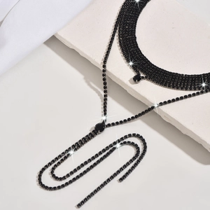 Close-up detail of luxury black rhinestone necklace set with shining crystals and tassels
