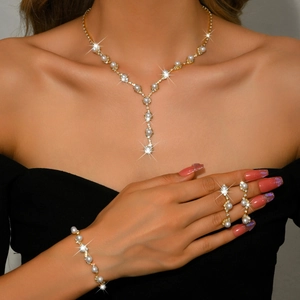 Elegant gold pearl jewelry set featuring necklace bracelet and drop earrings for women