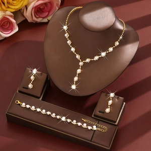 Elegant French pearl bridal jewelry set with gold tassels and shimmering crystal accents