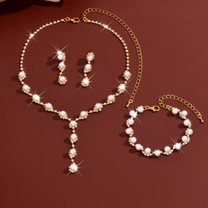 Golden bridal jewelry set with pearl sunflowers, necklace, earrings, and bracelet
