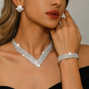 Luxurious silver V-shaped rhinestone bridal necklace with matching earrings and bracelet set