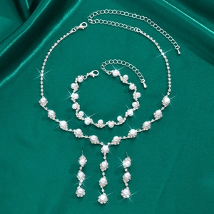Elegant silver necklace bracelet and earrings set with white pearls and rhinestones