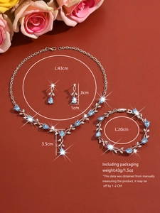 Macro shot of silver leaf jewelry set with blue pear-shaped stones and dimensions