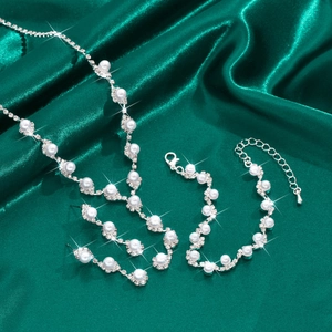 Detailed view of pearl and rhinestone jewelry set featuring necklace and earrings