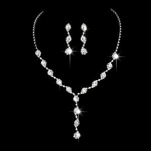 Detailed macro view of bridal jewelry set with sparkling rhinestones on black background
