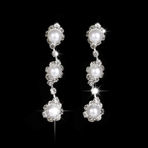 Detail of silver drop earrings with triple pearls and sparkling rhinestones