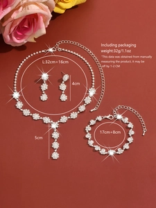 Detailed view of silver rhinestone jewelry set including necklace and floral earrings
