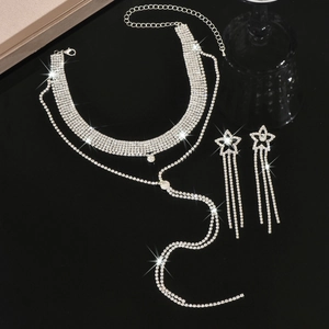 Detail of silver rhinestone Y-necklace with star fringe earrings on reflective background