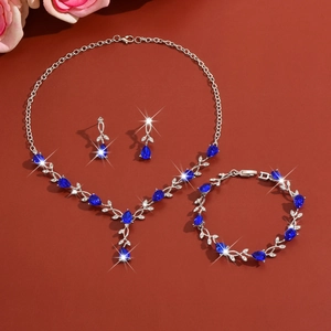 Elegant leaf jewelry set detail with blue zircon necklace, bracelet, and earrings