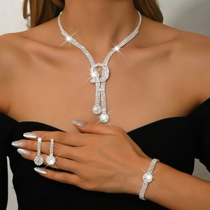 Detailed view of silver bridal jewelry set with sparkling rhinestones on model