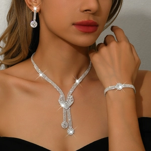 Elegant silver bridal jewelry set with sparkling crystal necklace, earrings, and bracelet