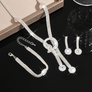 Detailed view of silver crystal bridal jewelry set featuring necklace, bracelet and earrings