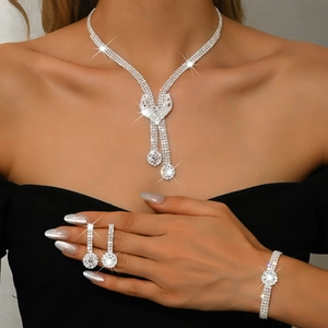 Detail of silver bridal jewelry set with sparkling crystal tassel necklace and earrings