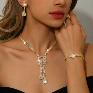 Sparkling gold jewelry set with rhinestone necklace, earrings, and bracelet for women