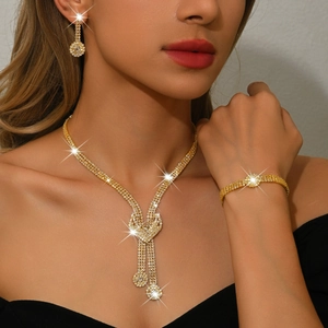 Elegant gold bridal jewelry set with sparkling crystal necklace, earrings and bracelet