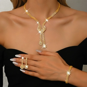 Detailed view of bridal jewelry set with crystal fringe necklace and matching bracelets