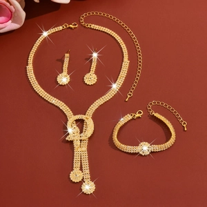 Detail of elegant gold-plated bridal jewelry set with sparkling rhinestones and tassels