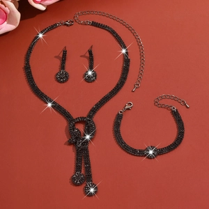 Close-up of black rhinestone bridal jewelry set featuring necklace with dangling pendants