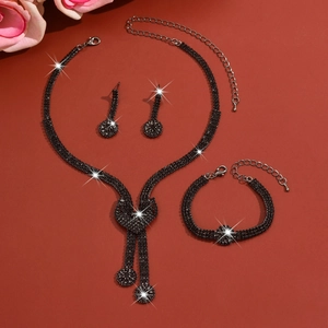 Detailed view of bridal jewelry set with black crystals including necklace and earrings